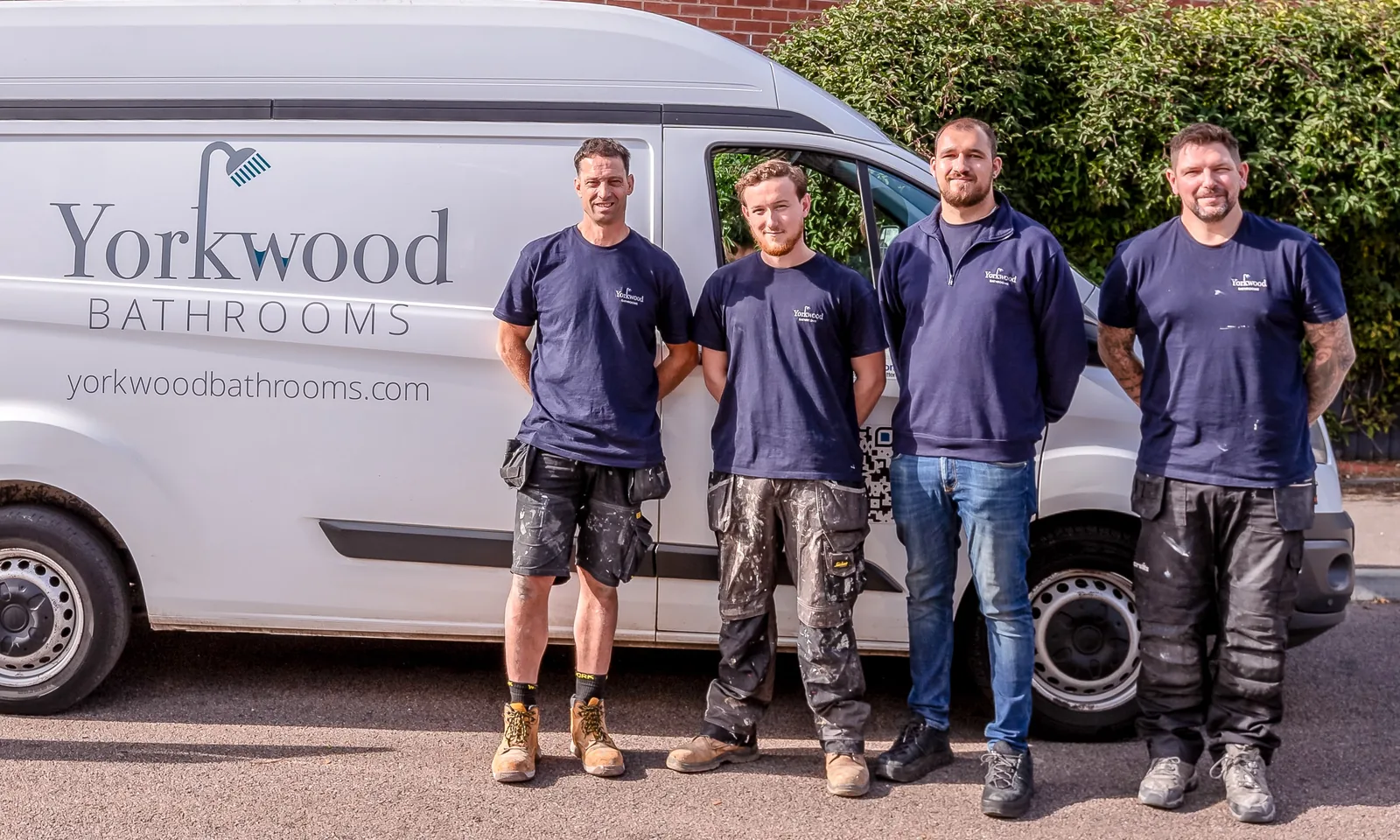 The Yorkwood Bathrooms team in branded tops beside their van